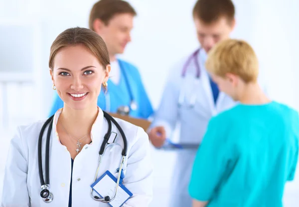 Attractive female doctor in front of medical group