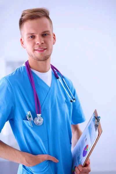 Male doctor standing with folder, isolated on white background