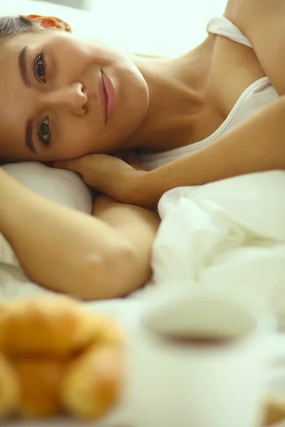 Young beautiful woman lying in bed