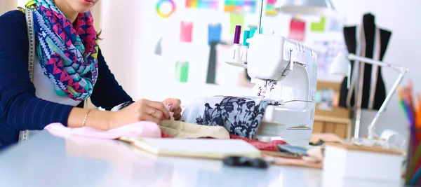 Dressmaker designing clothes pattern on paper