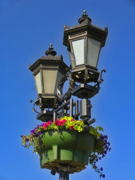 Vintage street lamps against bright blue sky