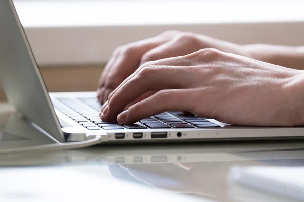 Young man typing on laptop