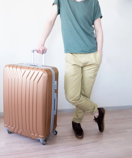 Standing with large baggage