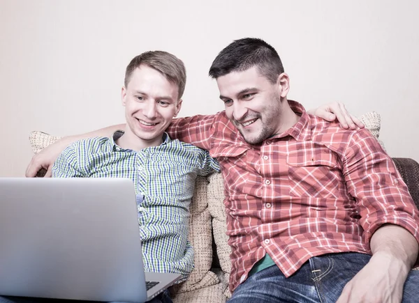 Two friends looking at computer