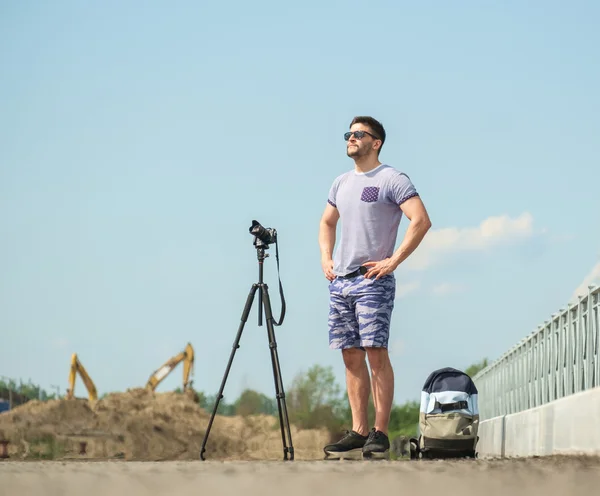 Man with camera on tripod