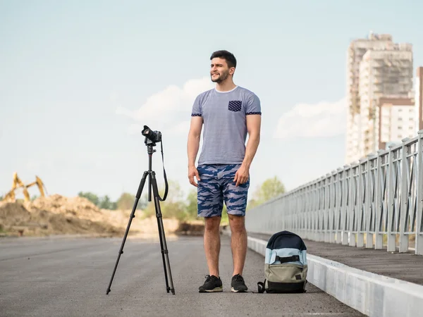 Man with camera on tripod