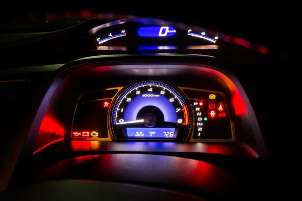 Modern car instrument dashboard panel and digital speed meter in night time