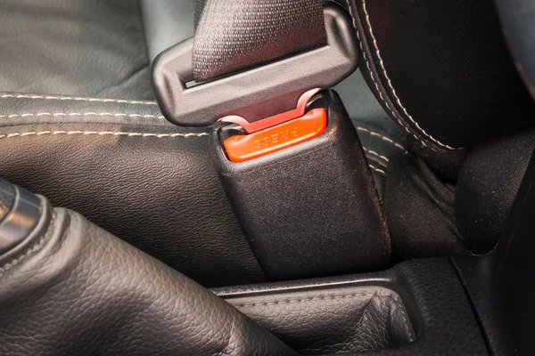 Close-up of the buckle of a seat belt or safety belt for driving and transportation by car.