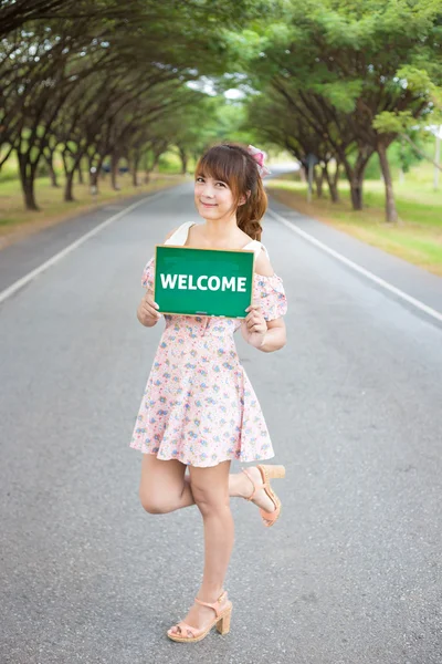 Cute woman hand holding green board sign with text \