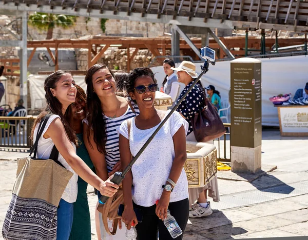 Four smiling multiethnic girls taking selfie