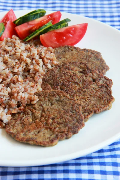 Chicken liver cakes with buckwheat and vegetables.