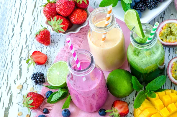 Berry and fruits smoothie in bottles, healthy summer detox yogur