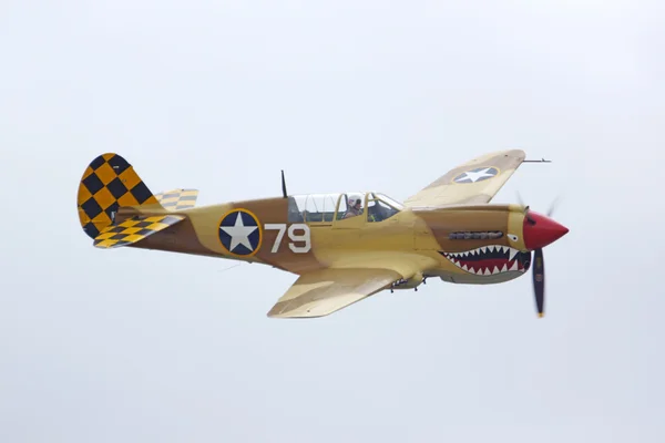 Airplane WWII P-40 Warhawk fighter flying at 2016 Planes of Fame Air Show