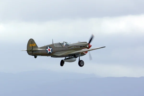 Airplane WWII P-40 Warhawk fighter flying at 2016 Planes of Fame Air Show