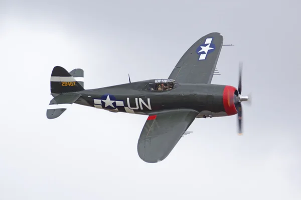Airplane WWII P-47 Thunderbolt fighter flying at 2016 Planes of Fame Air Show