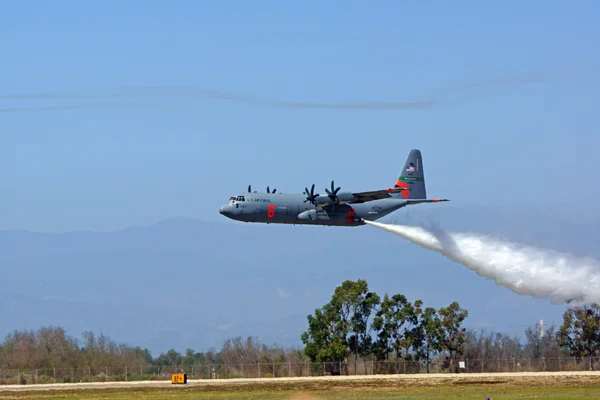 Airplane C-130 fire fighting aircraft water dropping demonstration at 2015 Air show