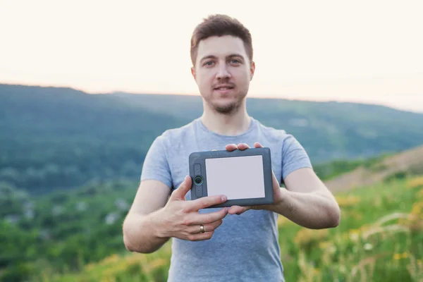 Man holding an ebook in front and touches the screen