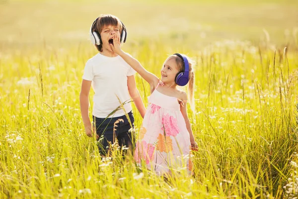 Funny kids listen music on nature