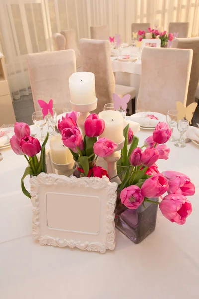 Wedding Table Decoration in pink colors. Table set for a wedding dinner. Beautiful flowers on table in wedding day