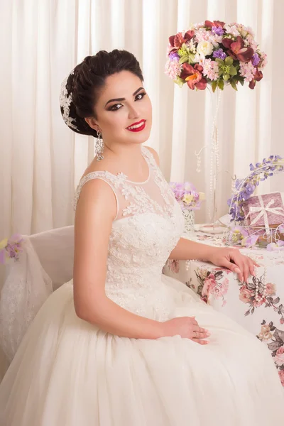 Young gorgeous bride. Beautiful and fashion bride in luxury interior. Beautiful and fashion bride with glamour makeup and hairstyle