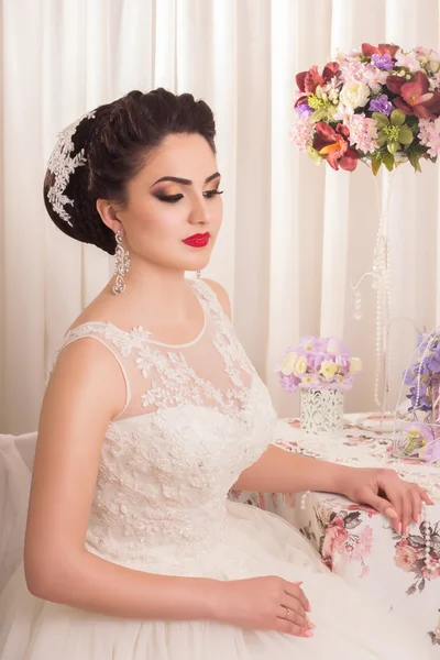 Young gorgeous bride. Beautiful and fashion bride in luxury interior. Beautiful and fashion bride with glamour makeup and hairstyle