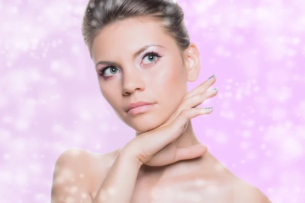 Beauty Spa Woman Portrait. Beautiful Girl Touching her Face. Isolated on pink background. Soft skin. Skincare concept. Snow.