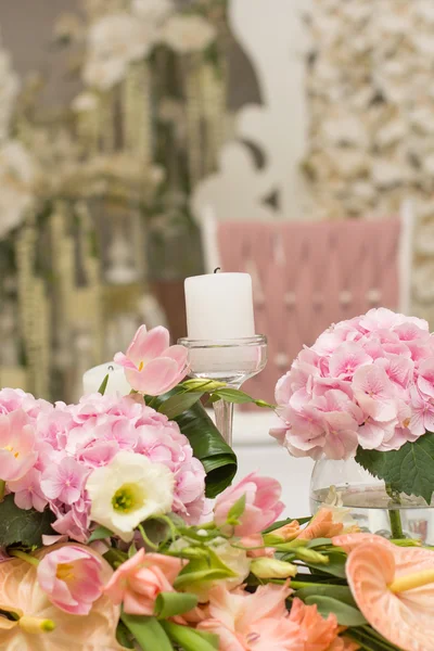 Wedding Table Decoration. Table set for a wedding dinner. Beautiful flowers on table in wedding day.