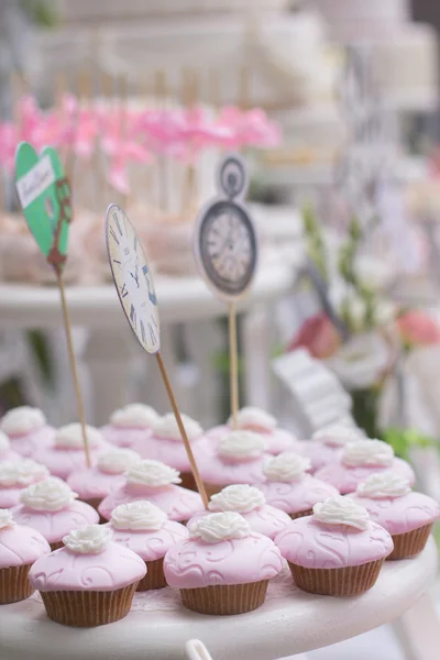 Tray with delicious cakes. Elegant sweet table with big and small cakes, cupcakes, cake pops on dinner or event party. Cake pops. Tray with delicious cakes