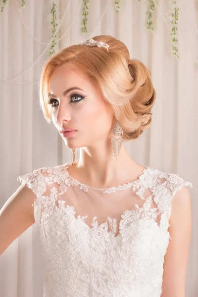 Beauty woman with wedding hairstyle and makeup. Bride fashion. Jewelry and Beauty. Woman in white dress,perfect skin. Girl with stylish haircut.