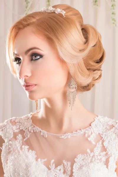 Beauty woman with wedding hairstyle and makeup. Bride fashion. Jewelry and Beauty. Woman in white dress,perfect skin. Girl with stylish haircut.