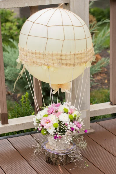 Wedding decoration with a balloon with flowers, ribbons and bows. Beautiful flowers in wedding day.