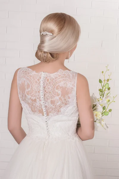 Wedding. Beautiful bride. Beauty woman with wedding hairstyle and makeup. Bride fashion. Jewelry and Beauty. Woman in white dress,perfect skin, blond hair. Girl with stylish haircut.