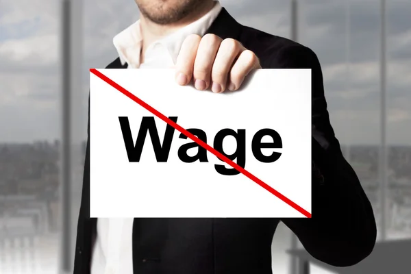 Businessman holding sign wage crossed out