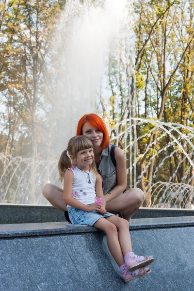 Two beauty girls on fountain