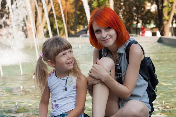 Two beauty girls on fountain