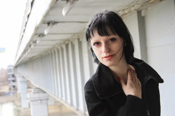 Goth Girl walks on bridge