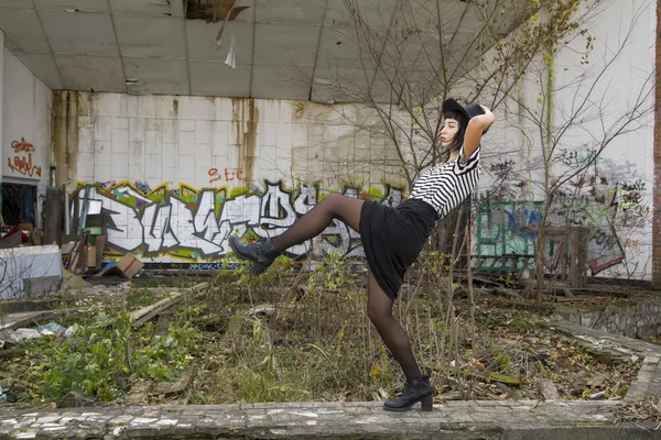 Young pretty gothic girl walks on ruine