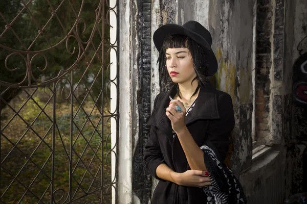 Young pretty gothic girl walks on ruine