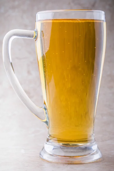 Full glass of beer isolated on white with a foam