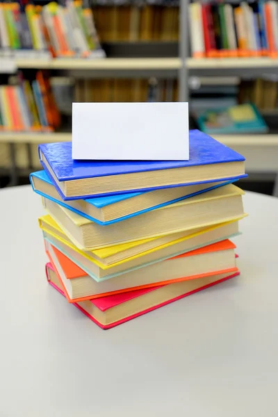 Stacked books. Books in the library. Pile of books. Colorful books. Blank card. Insert your own text.