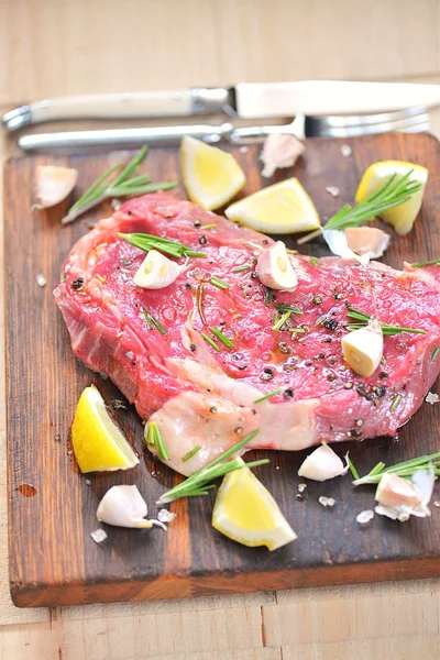 Raw steak with garlic and lemon