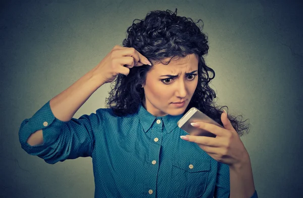 Frustrated upset young woman surprised she is losing hair