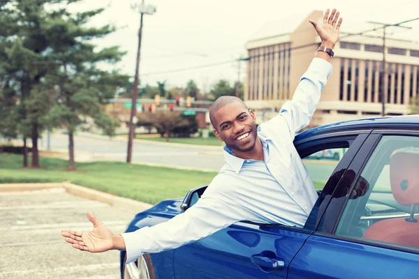 Happy excited man coming out of a car\'s window