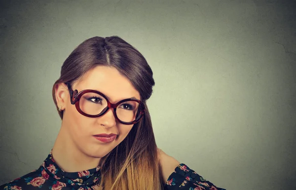 Funny confused skeptical woman in glasses thinking looking perplexed