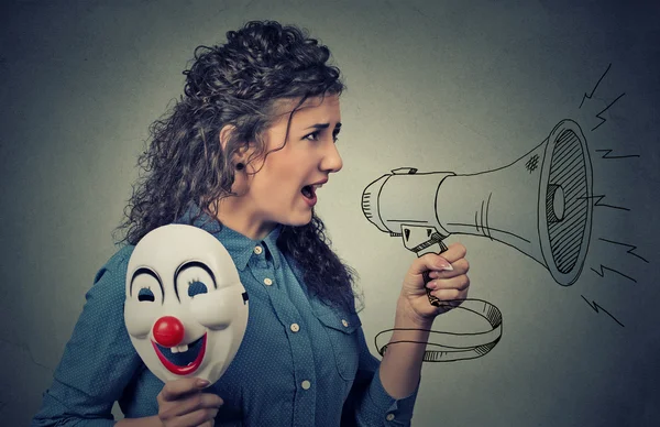 Woman with megaphone and clown mask screaming