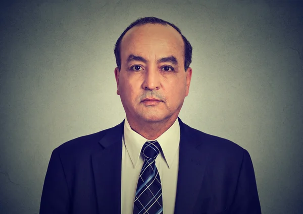Head and shoulders shot of a middle aged business man in a suit and shirt with ti