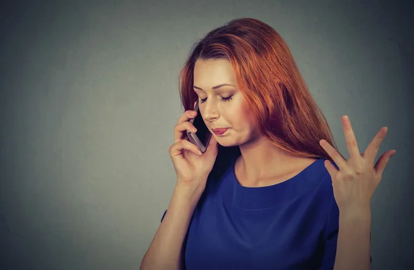 Upset sad, unhappy, serious woman talking on phone displeased with conversation