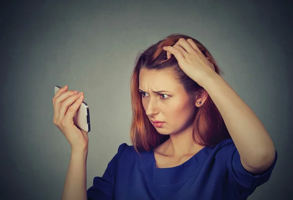 Unhappy frustrated upset woman surprised she is losing hair, receding hairline