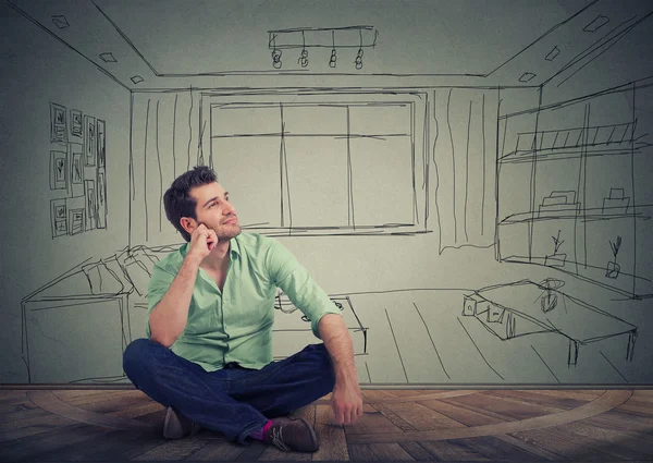 Dreaming man isolated over drawn living room background.