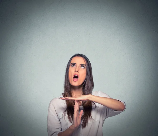 Woman showing time out hand gesture, frustrated screaming to stop